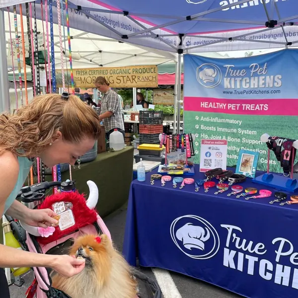 A shopper choosing treats at the booth