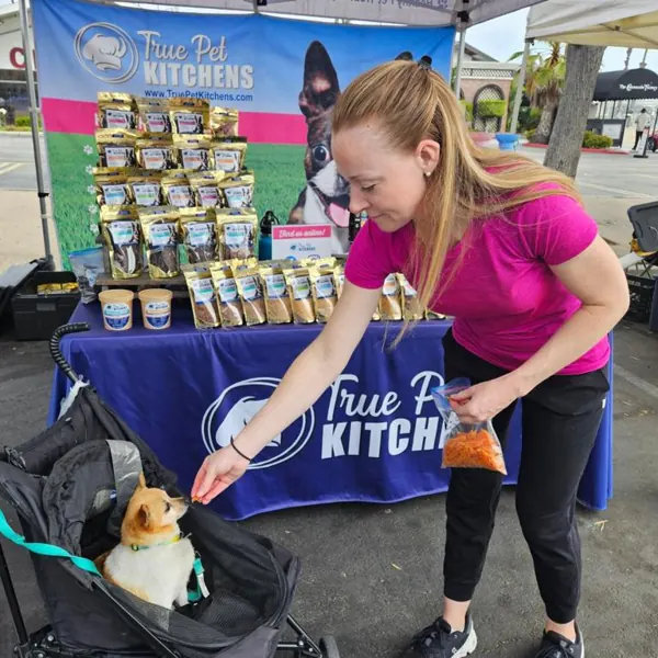 Handing out treats at the market booth