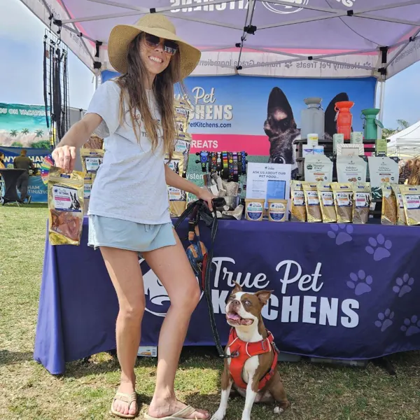 A customer and her dog at the booth